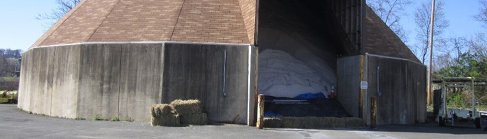 Photo of a concrete storage building containing salt for roadway de-icing operations.